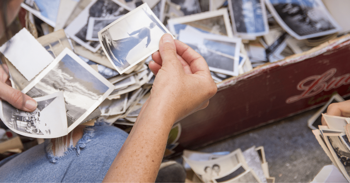 an elderly man looking at his family photo album