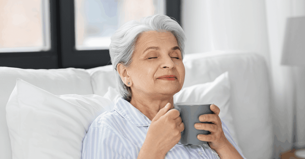 old woman smelling coffee