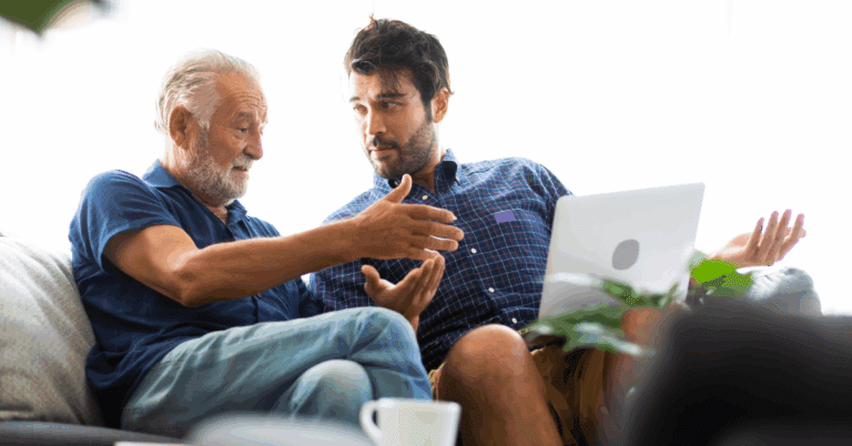 a senior dad talking with his son at independent living