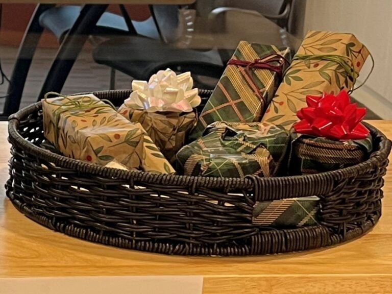 Basket containing several gift wrapped packages.