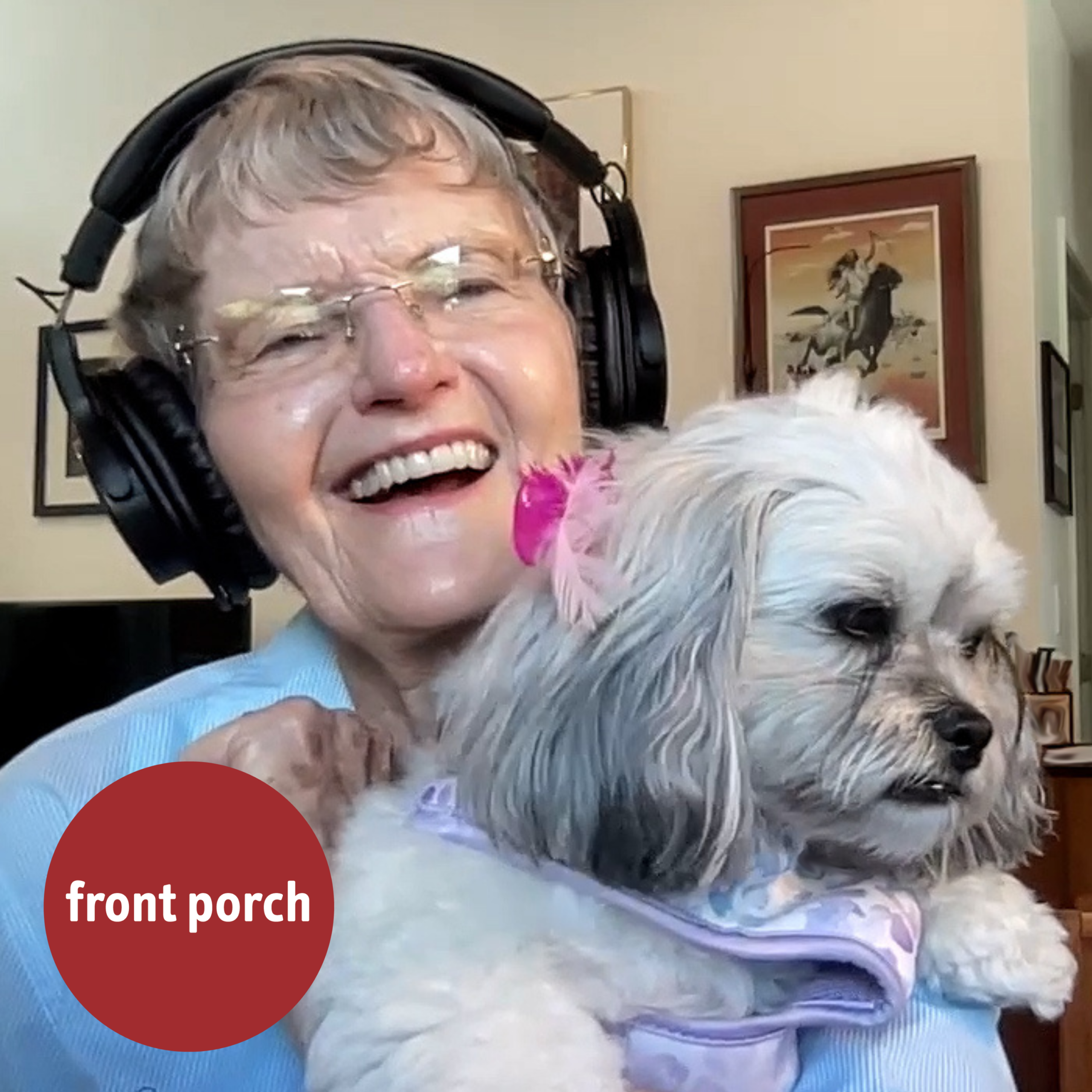 An older woman wearing headphones holds up a small dog. The Front Porch logo is in the lower lefthand corner.