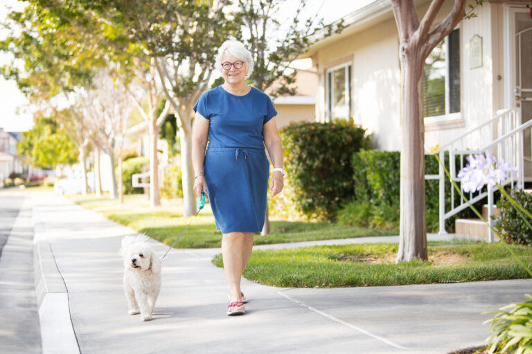 senior walking with her dog in senior community