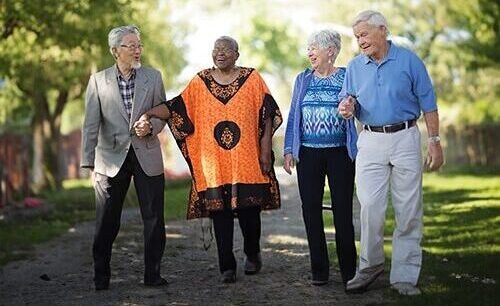 Careers 7 Four Older Adults Stand Together Outside.