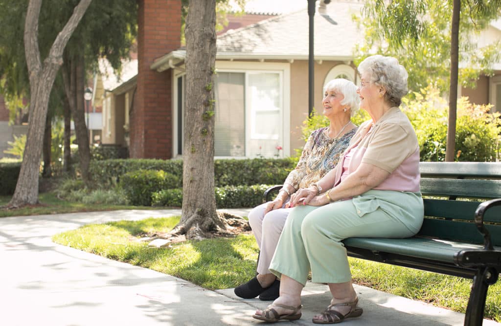 The Ultimate Guide To Finding A Senior Living Community That Feels Like Home 2 Seniors Sitting In Senior Living Community