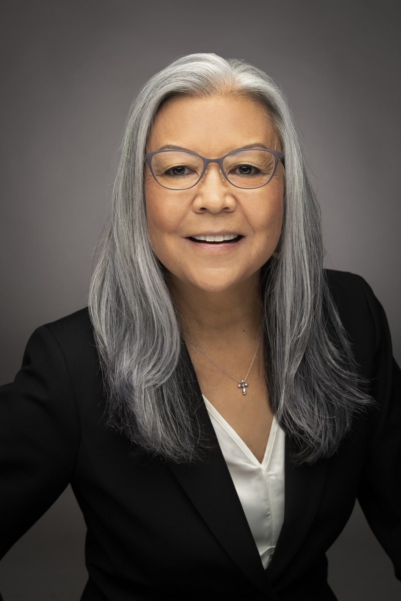 Home Match 8 A Woman Wearing Glasses And A Black Blazer.