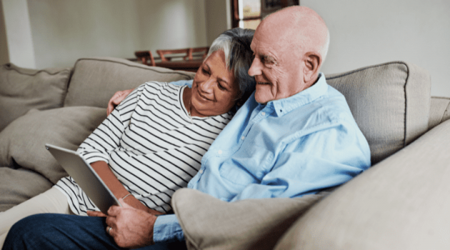 an elderly couple hugging