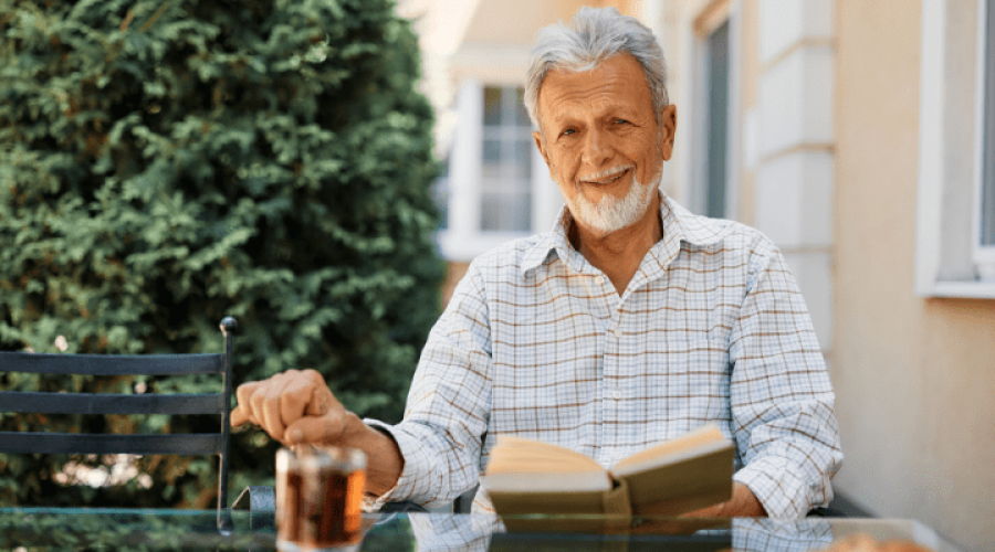 an old man reading a book