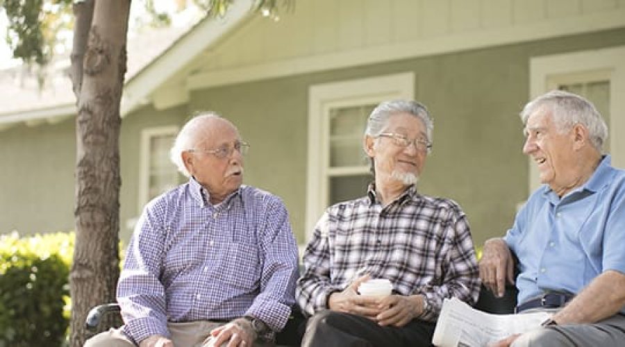 Image of smiling residents outside of Claremont Manor