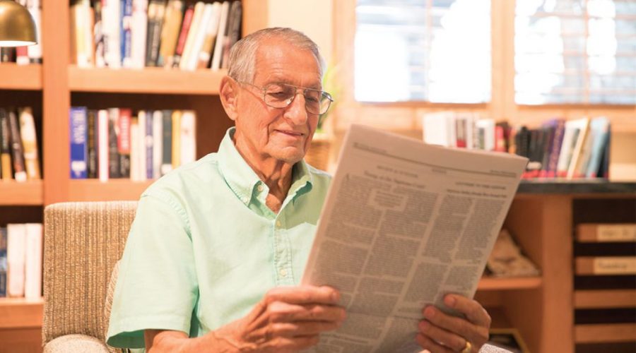 a senior men reading a newspaper