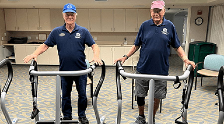 Two men wearing matching polos stand in S3 Balance devices.