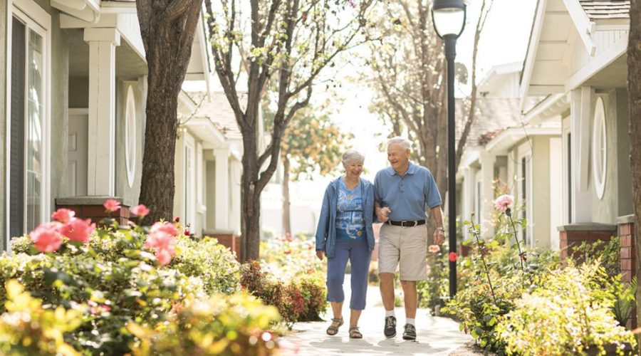 a couple walking in a senior living community