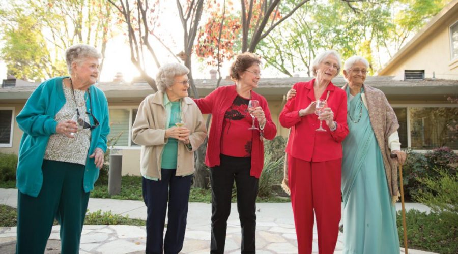 Group photo of senior women enjoying a glass of wine outdoors at Summer Villa