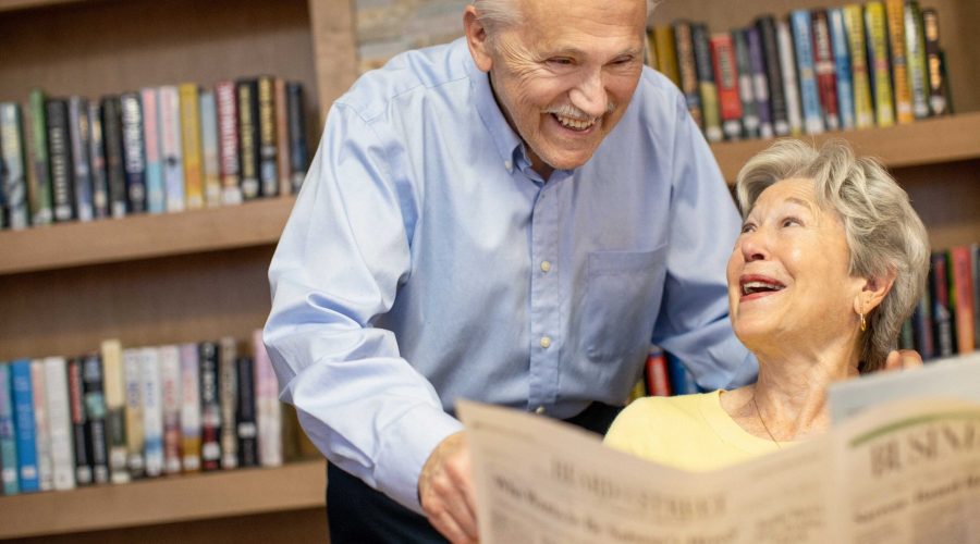 two seniors reading the newspaper