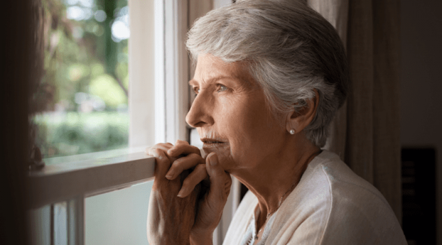 a woman alone looking out the window