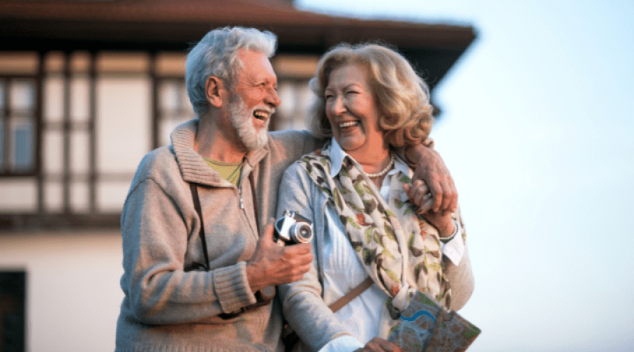 a couple of seniors laughing an hugging each other