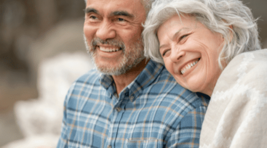 elderly couple together with woman laying her head on mans shoulders